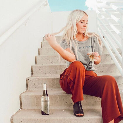 Woman on Steps Sipping White Wine