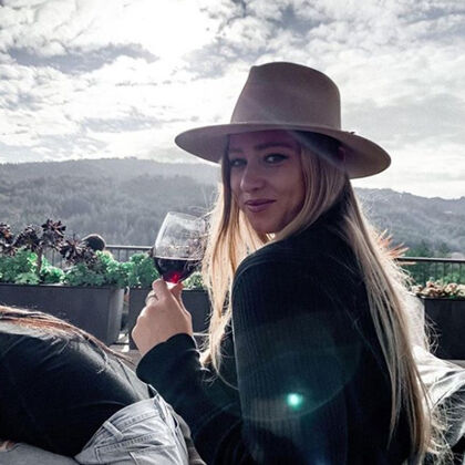 Guest Sipping Red Wine on Sterling Terrace Overlooking Napa Valley